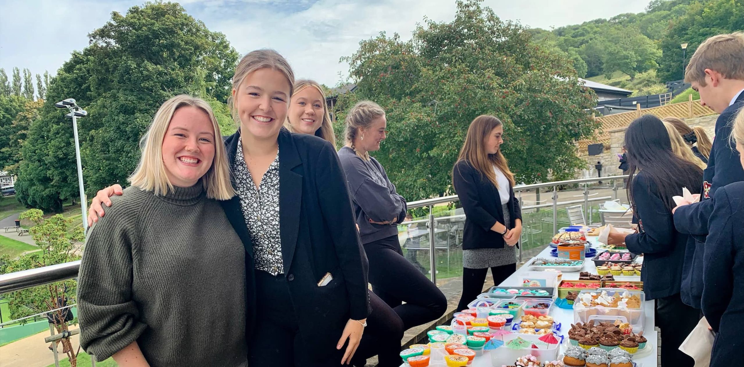 Two students at a KES Bath cake sale